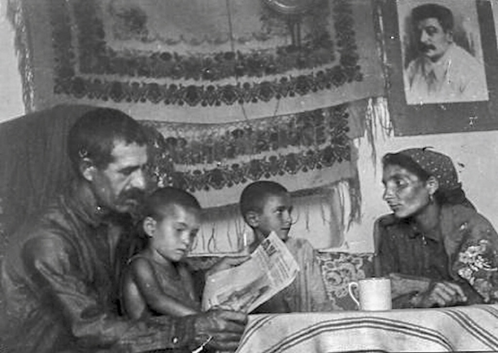 Gypsy Family. Crimea, USSR, 1930. Photo annotation: “Stakhanovite collective farmer of the Gypsy Beshkur Vakuf kolkhoz of the Seytler rayon Dalda Asanov with his family in a new house built for him by the kolkhoz.”