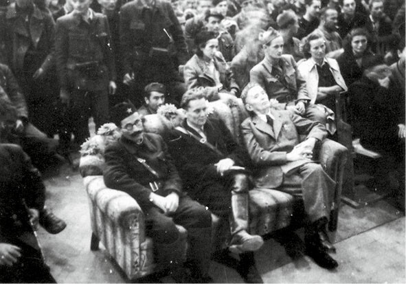 Von links: Milutinović, Tito und Ribar in Bihać 1942 beim Betrachten der Theateraufführung „Verdächtige Person“, Muzej AVNOJ-a
