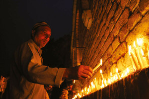 A man lights candles outside his house on Shab-i Barat. Srinagar, Kashmir
