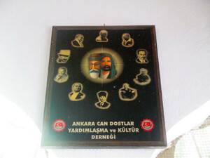 Poster depicting Ali and Abdal Musa surrounded by photographic images of Atatürk, placed between two arches in the foyer of the shrine of Abdal Musa