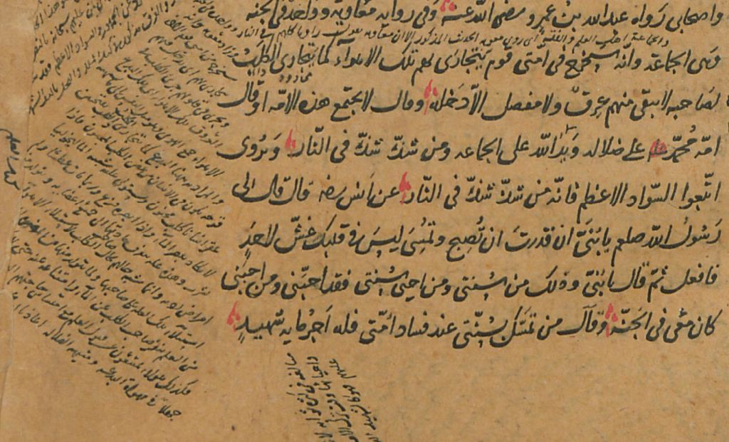 A manuscript containing Arabic text, with symbols in red added to the main text and with additions in the margins.