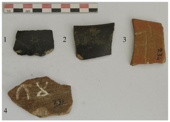 Four inscribed potsherds with numbers. Potsherd numbers 1 and 2 are black in color and each has one BrÄhmÄ« letter. Potsherd number 3 is red in color and has one BrÄhmÄ« letter. Potsherd number 4 is brown in color and has two letters.