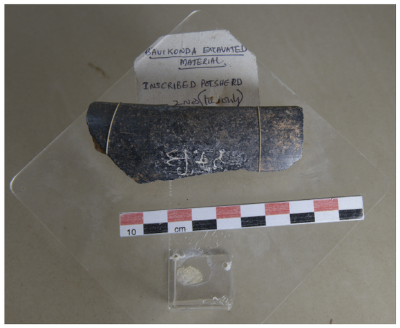 A fragment of the rim of a bowl in black color. It carries three BrÄhmÄ« letters.
