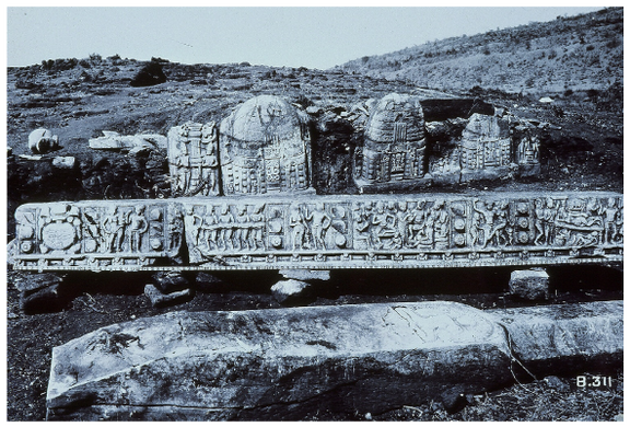 An old picture of the site 6. It shows the base of the stūpa decorated with limestone sculptures.