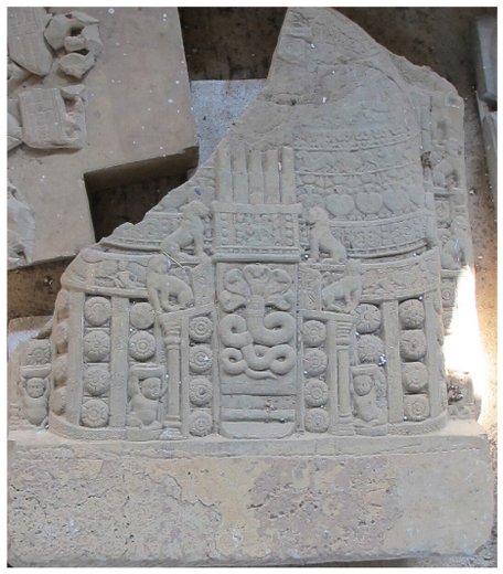 It depicts a miniature stÅ«pa with intricate carving on the dome and the drum. A serpent or nÄgÄ is placed at its entrance.