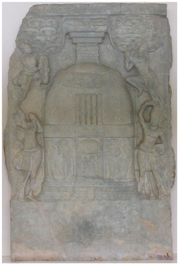 It depicts a miniature stūpa with sprouting umbrellas on the top. Two flying figures and two standing figures venerate the stūpa. The base section of the stūpa depicts attendant figures holding flowers.