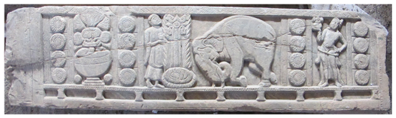 It depicts a vase, an elephant bowing before the symbolic representation of the Buddha, and a male attendant figure holding a vase.